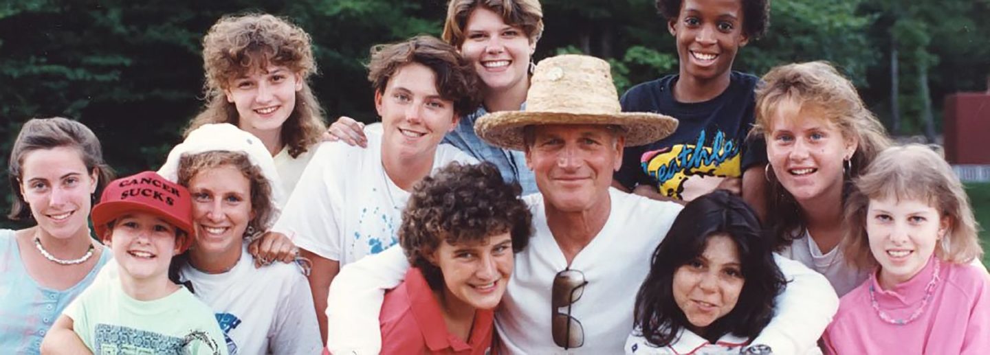 Paul Newman poses for a photo with campers at one of his Serious Fun camps for children with serious illness and medical conditions.