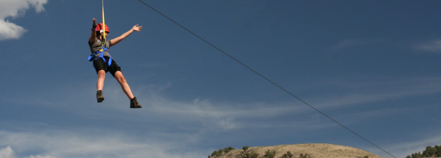 A camper ziplines at Roundup River Ranch camp for youth
