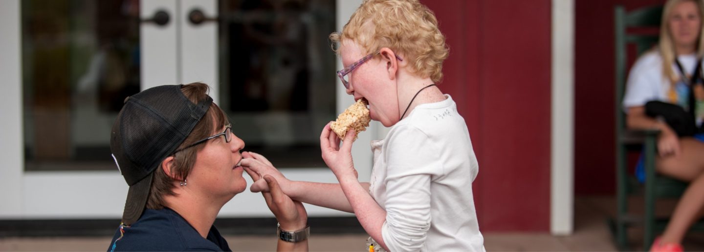 A camper enjoys a snack at Roundup River Ranch summer camps in Colorado