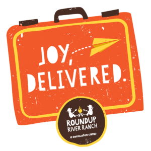 A small badge promotes the Joy Delivered program at Roundup River Ranch nonprofit summer camp in Colorado