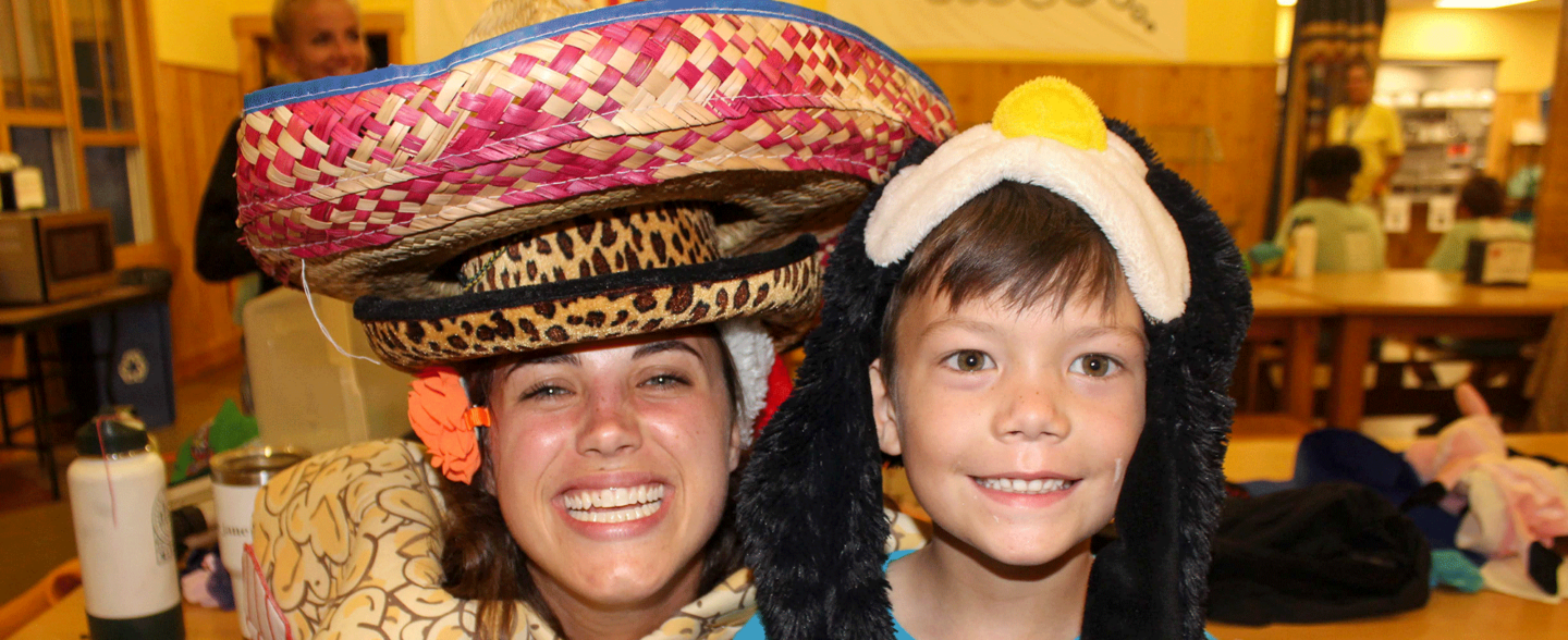 Roundup River Ranch volunteer dressed up with a camper. Learn more about how to volunteer and additional camp counselor opportunities.