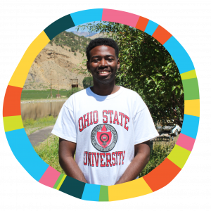 Colorful circle border with Volunteer Jamel wearing a white Ohio State University T-Shirt